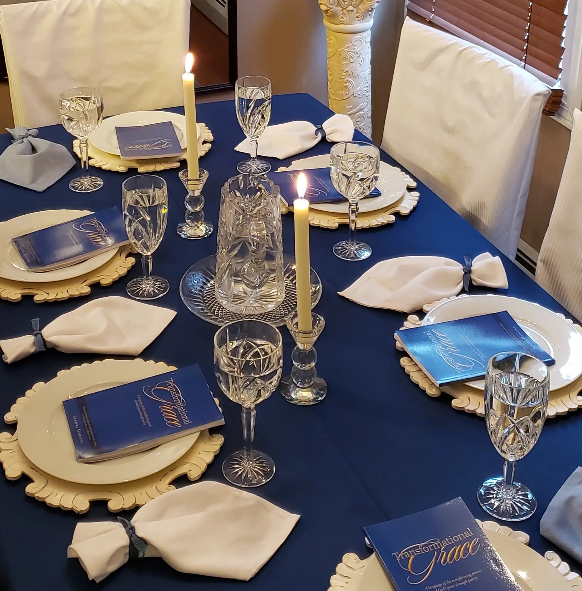 The Mentor's Table set for guests with candles, crystal, and place settings